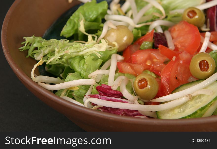 Salad with chopped tomatoes, olives, sprouts and cucumbers. Salad with chopped tomatoes, olives, sprouts and cucumbers