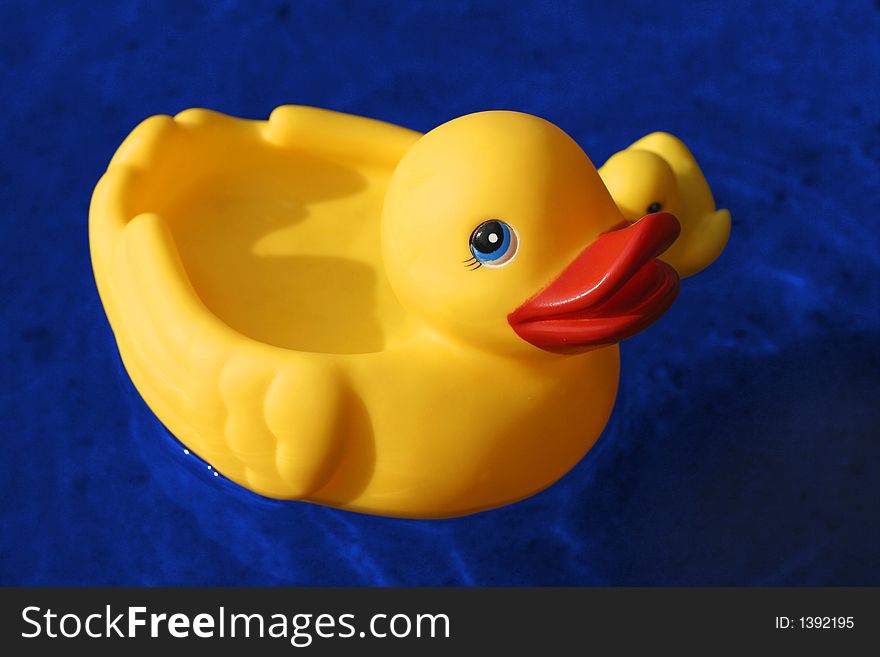 Yellow rubber duck family and blue water. (with clipping path). Yellow rubber duck family and blue water. (with clipping path)