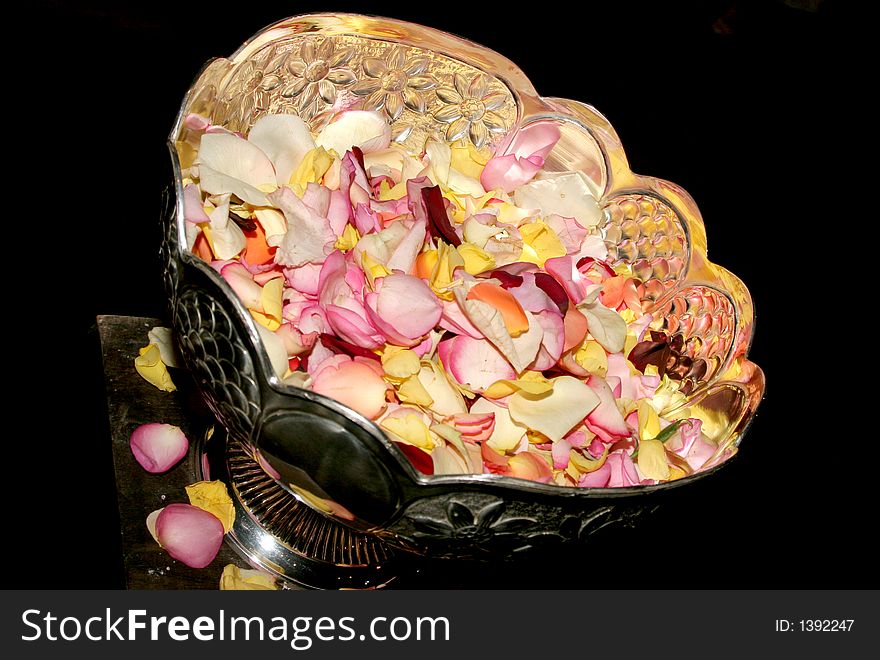 A stainless bowl filled with rose petals for confetti. A stainless bowl filled with rose petals for confetti