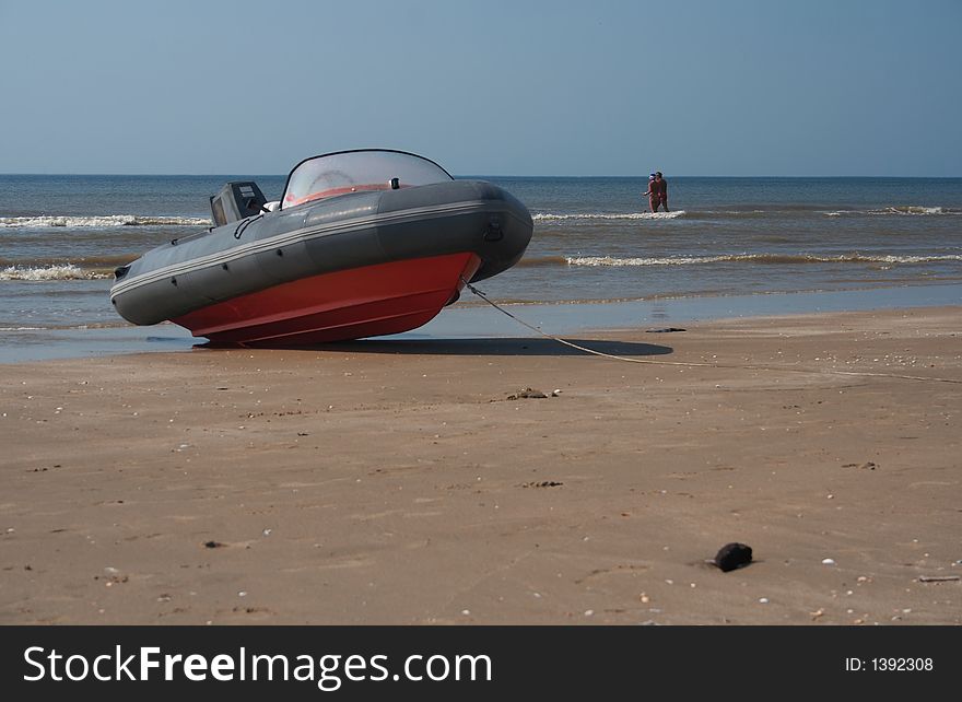 A speedboat on the beach with the sea on the horizon. A speedboat on the beach with the sea on the horizon
