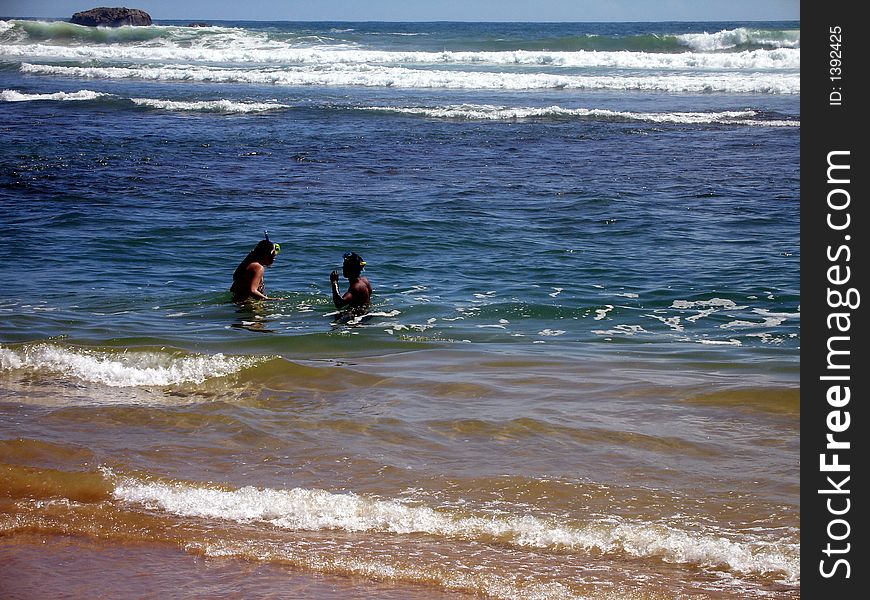 Two people are diving at the ocean