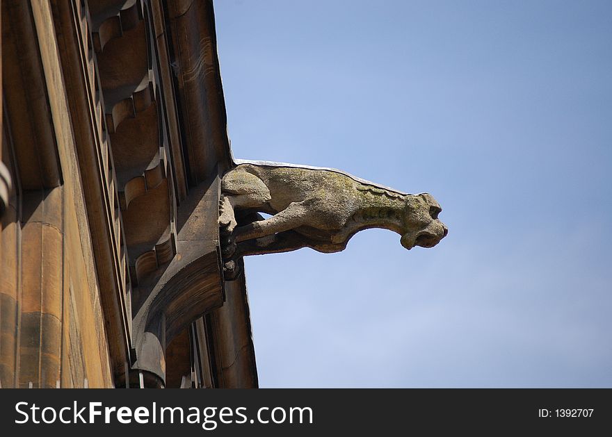 Gargoyle sculpture on roof in Cambridge, England