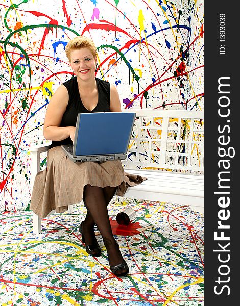 Business woman with laptop in paint splash background.