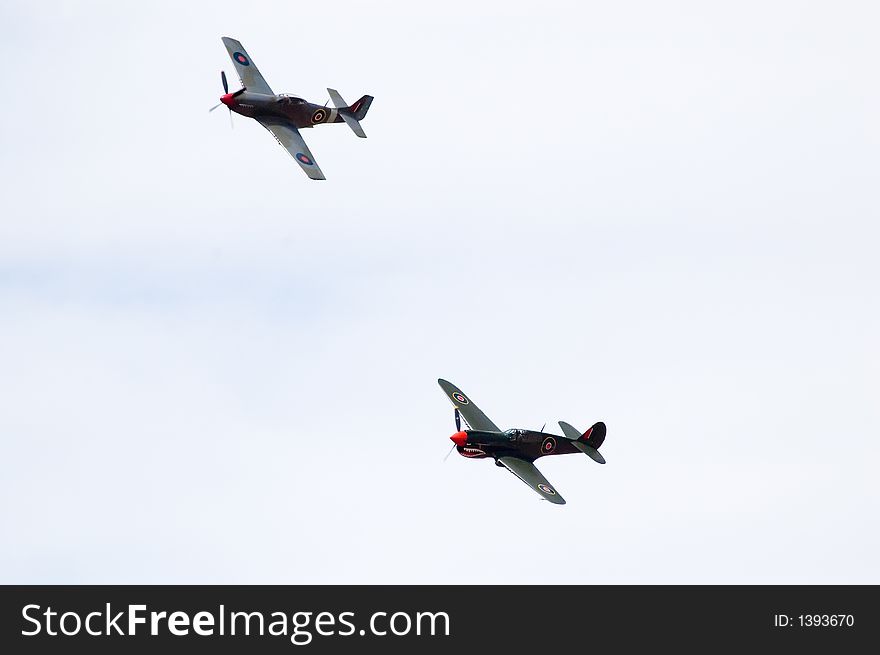A P40 Kittyhawk and a CA-18 fly past during an air show. A P40 Kittyhawk and a CA-18 fly past during an air show.