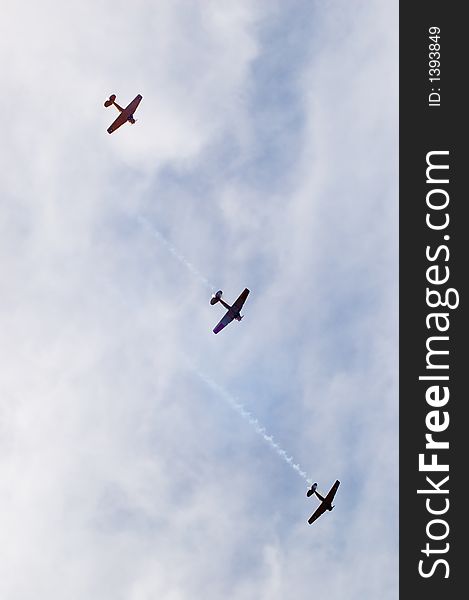 Harvard T-6's fly past during an air show. As seen from below. Harvard T-6's fly past during an air show. As seen from below.