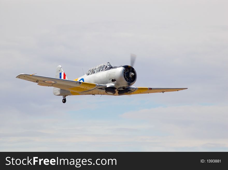 A T-6 Harvard zooms past at an air show. A T-6 Harvard zooms past at an air show.