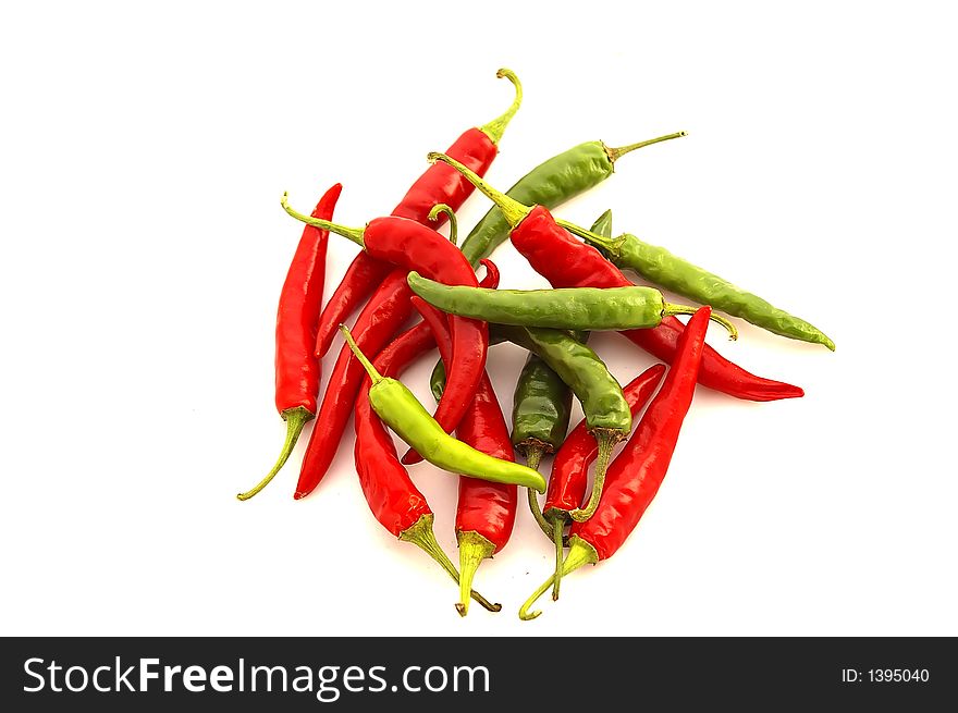 Isolated closeup of a pile of ripe Red and Green chili peppers. Isolated closeup of a pile of ripe Red and Green chili peppers