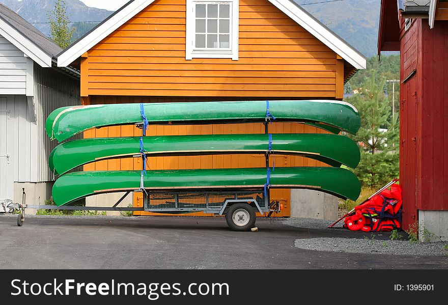 Green canoes stacked on a hanger