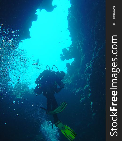 Diver ascending towards the light. Diver ascending towards the light