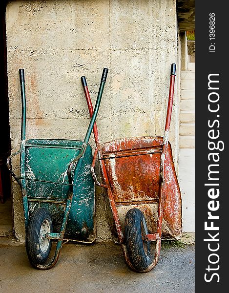 Nice contrast between old green and red hand-carts. Nice contrast between old green and red hand-carts.