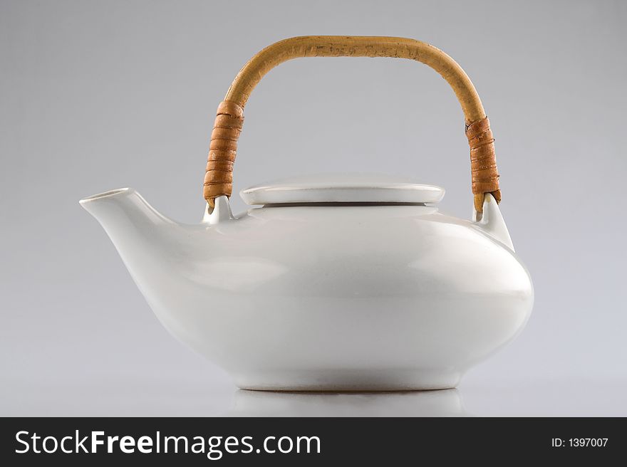White kettle with straw hand isolated on white