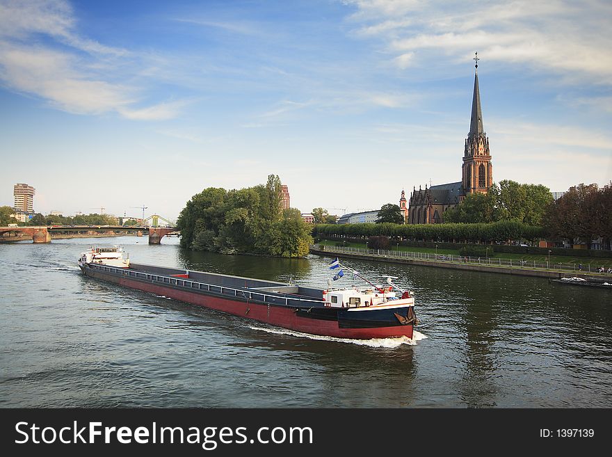 A barge moving along the Main River in Frankfurt, Germany. A barge moving along the Main River in Frankfurt, Germany