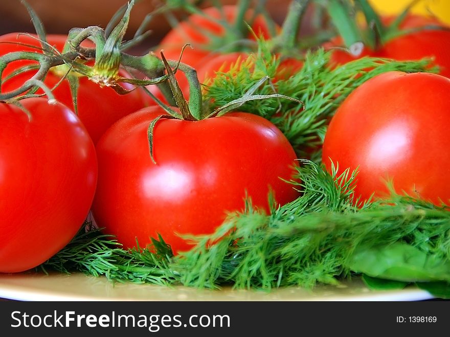 A bunch of lovely red fresh tomatoes in focus. A bunch of lovely red fresh tomatoes in focus
