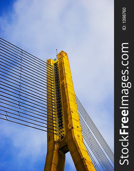 Modern Yellow Cable bridge closeup on blue sky