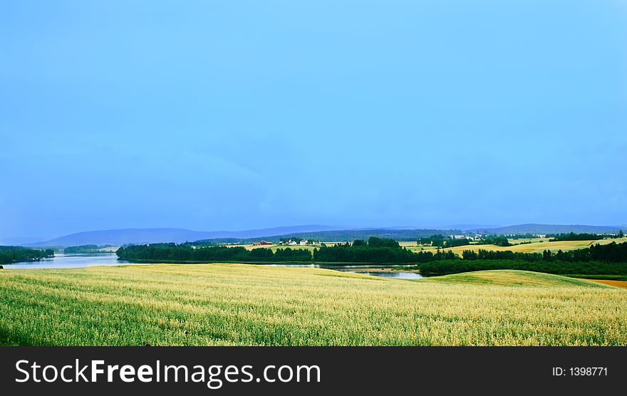 Wheat fields, a river and distant hills in the southern Norway, near the Swedish border. Wheat fields, a river and distant hills in the southern Norway, near the Swedish border.