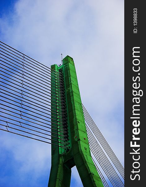 Modern Green Cable bridge closeup on blue sky