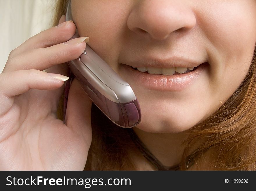 Girl speaking by the phone (close up)