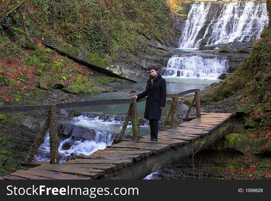 Wild waterfall with bridge