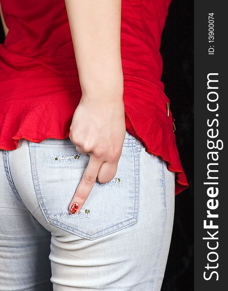 Hand girl with the middle finger in jeans pocket. Hand girl with the middle finger in jeans pocket