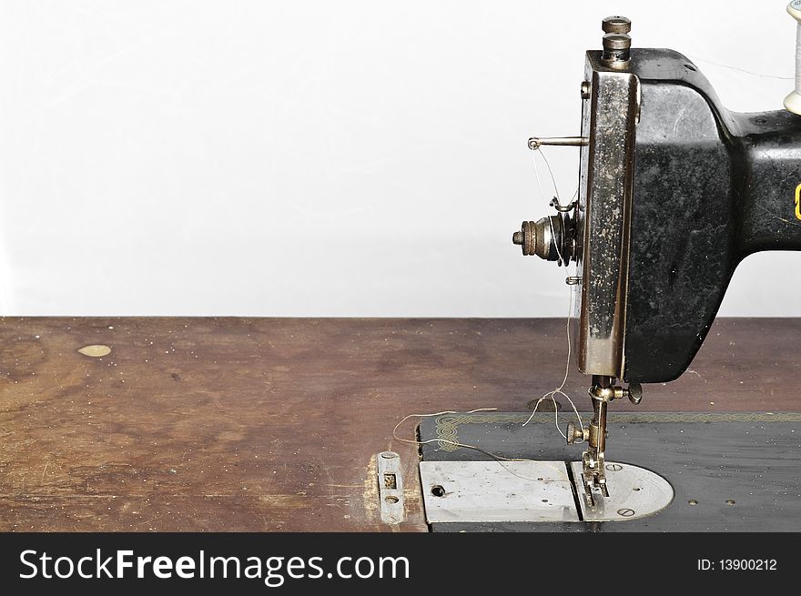 Old black sewing machine on white background