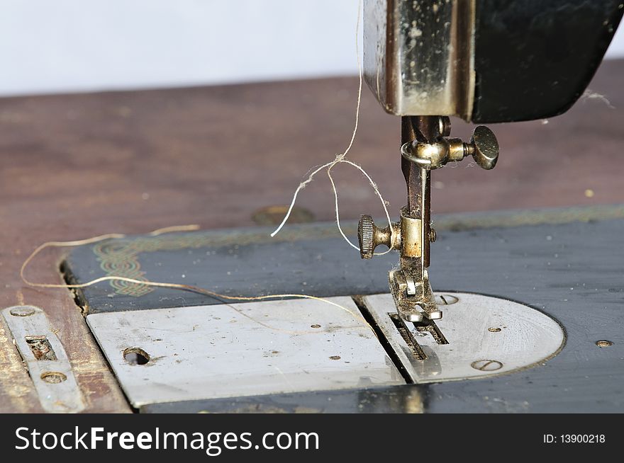 Old black sewing machine on white background