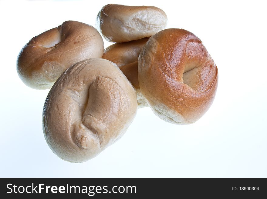 A pile of bagels isolated against a white background