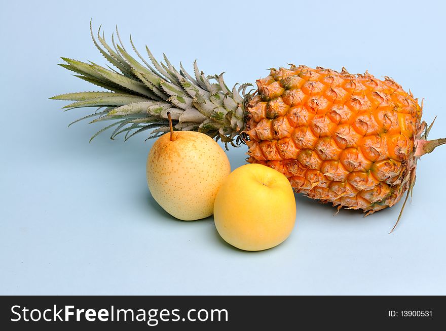 Light blue background of pineapple, apple, pear. Light blue background of pineapple, apple, pear.