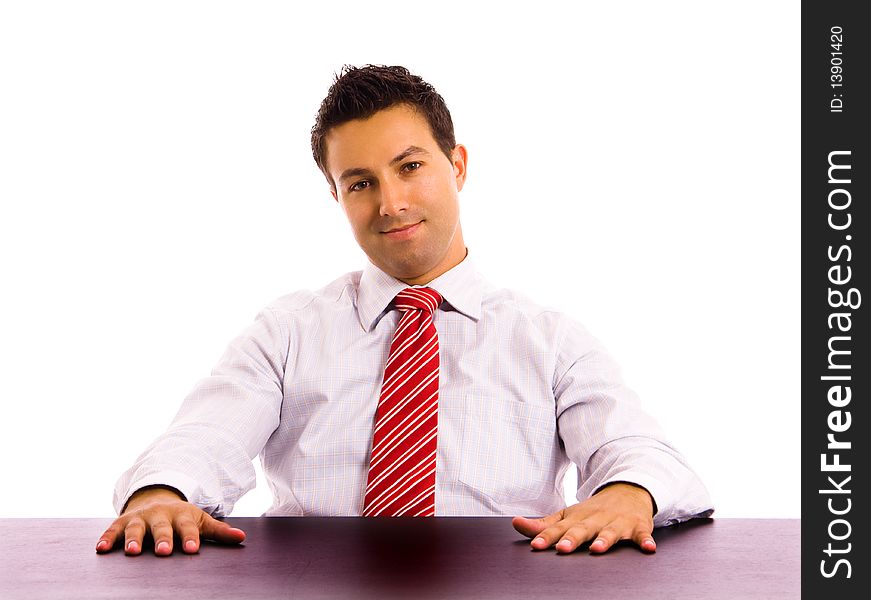 Young business man on a desk, isolated on white