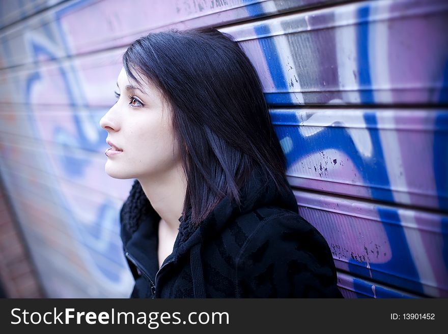 Young beautiful teen in pensive gesture in street background. Young beautiful teen in pensive gesture in street background.
