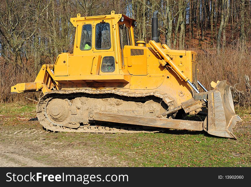 Heavy building bulldozer of yellow color