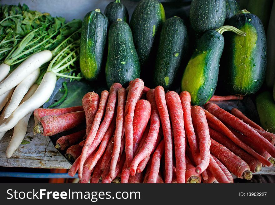 Green vegetable, carrot and radish on market.