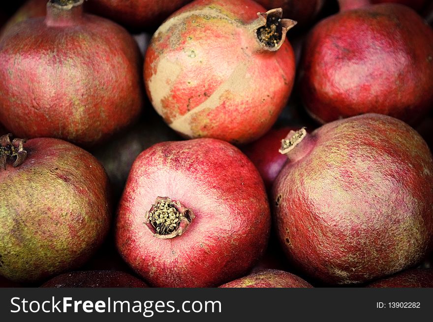 Few red mellow pomegranates in range.