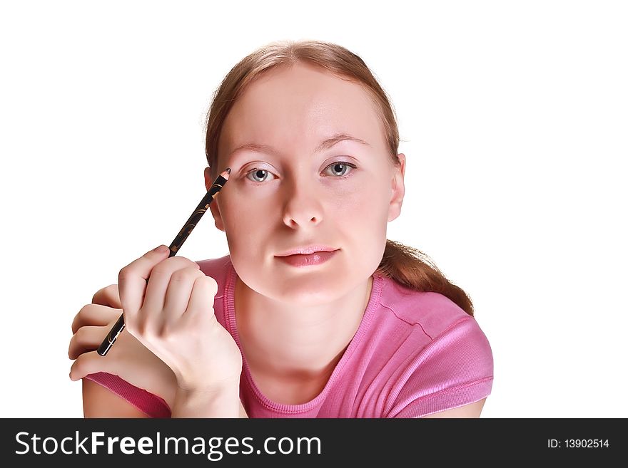 She paints a black eye pencil on a white background. She paints a black eye pencil on a white background