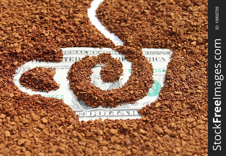Natural granulated coffee close up on dollars