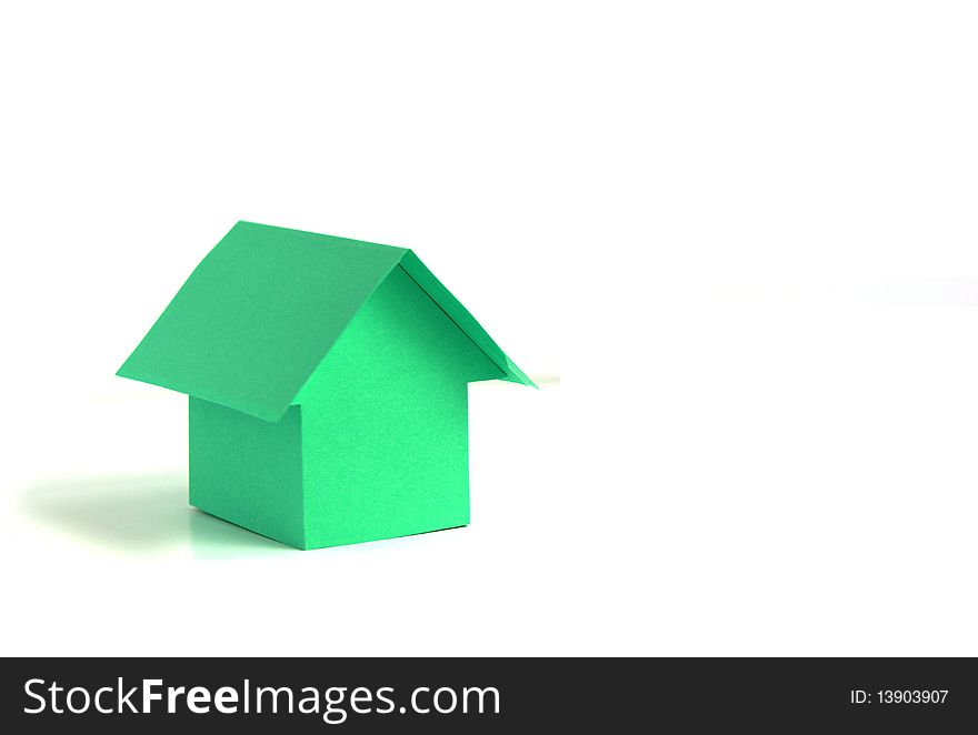 Green paper house isolated on white background