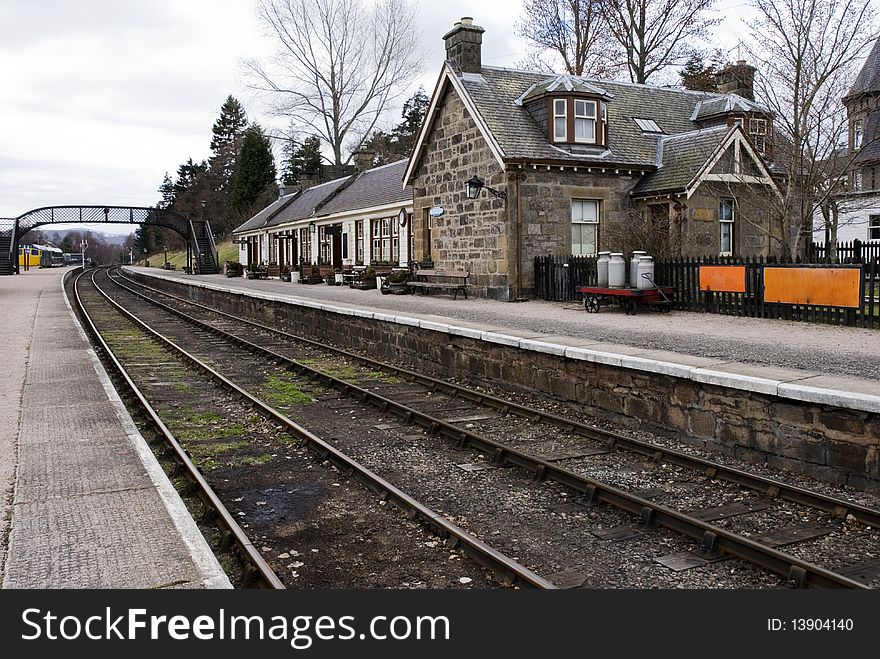 A horizontal image of an old deserted railway station in the highland region of Scotland