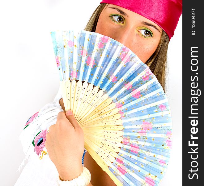 beautiful young girl waving a fan, indoor shoot