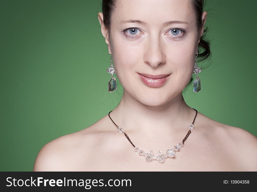 Portrait of a beautiful caucasian young woman with beautiful black hair on green. Portrait of a beautiful caucasian young woman with beautiful black hair on green