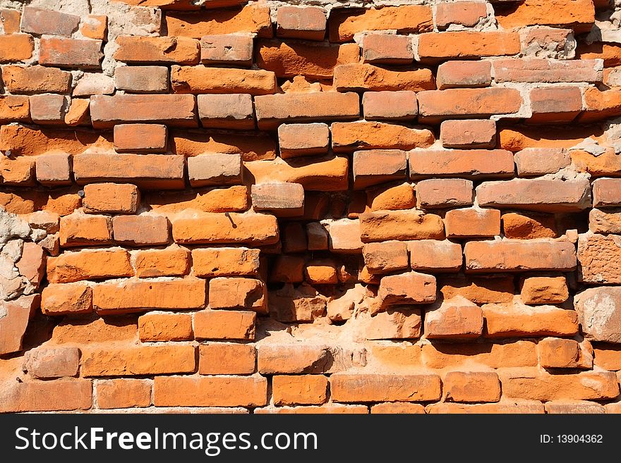 It depicts an old brick wall crumbling. It depicts an old brick wall crumbling