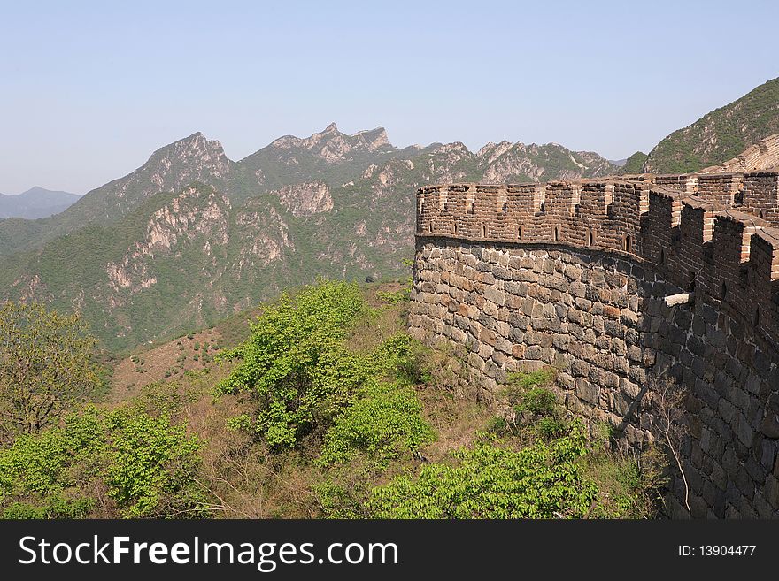 View to section of great wall close to Beijing. Mountains in the background, clear sky. Picture taken in the spring time. View to section of great wall close to Beijing. Mountains in the background, clear sky. Picture taken in the spring time