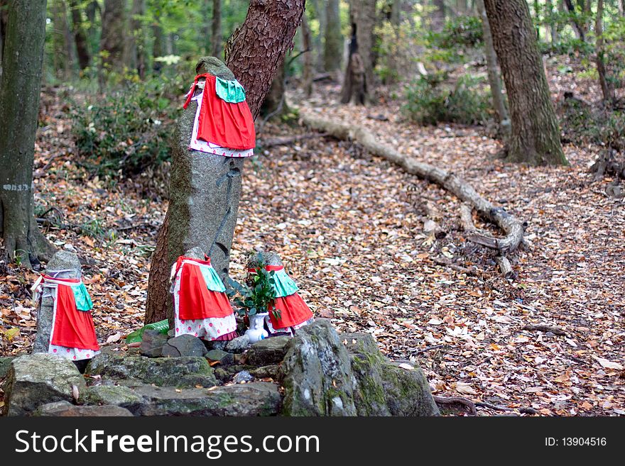 Four kamis with red clothes in the forest