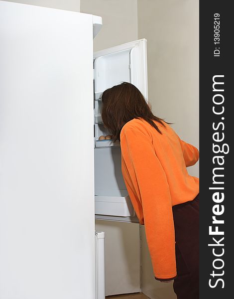 A Woman Looking In A Refrigerator