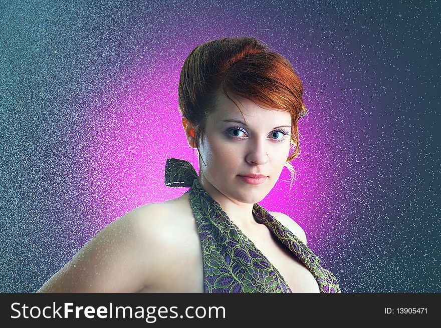 The close-up portrait of a young ginger lady under the rain