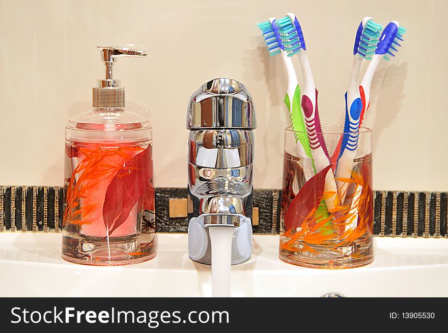 Liquid Soap, Faucet And Four Toothbrushes