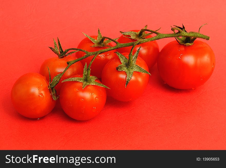 Red tomatos on red background
