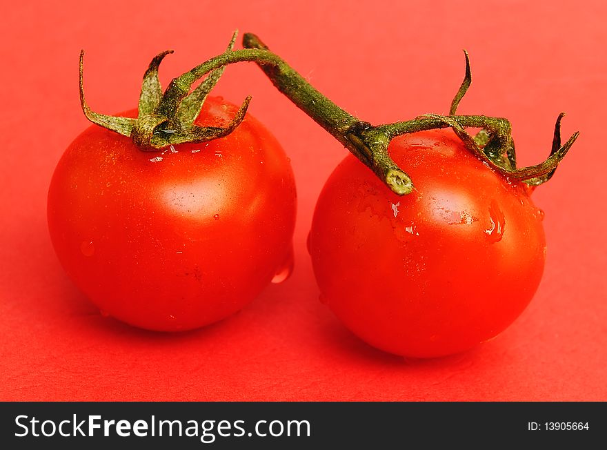 Red tomatos on red background