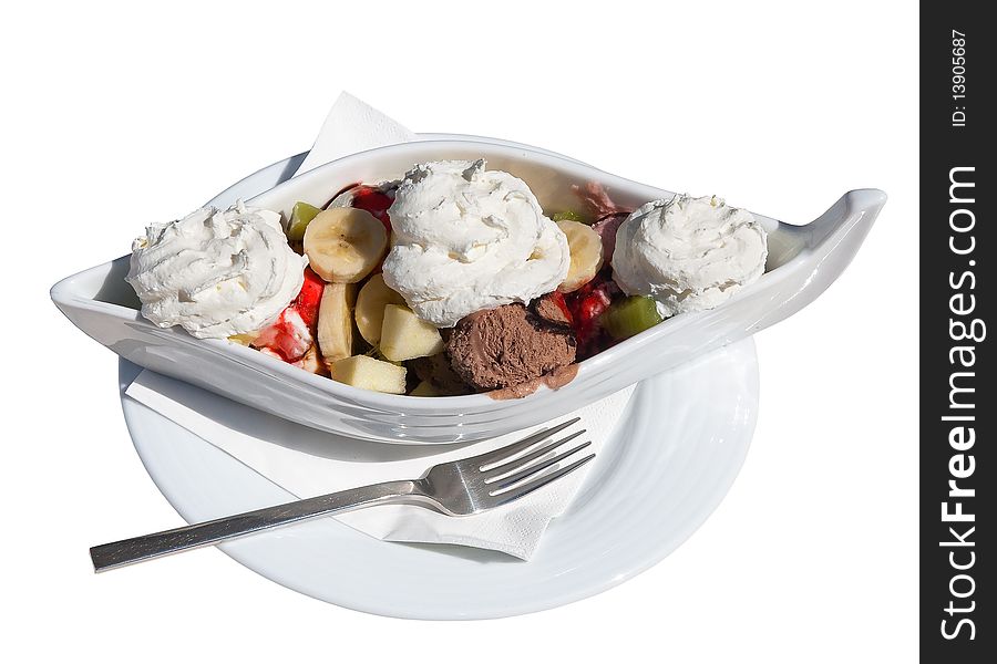 Ice cream and fruit in a white rook on tarleke with a napkin and fork. Isolated. Ice cream and fruit in a white rook on tarleke with a napkin and fork. Isolated.