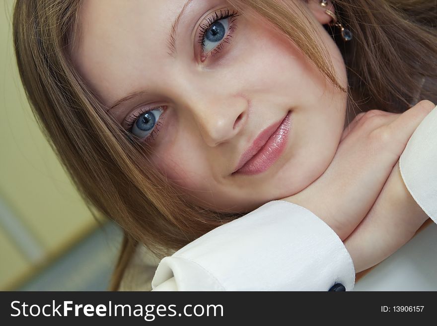 Portrait of young beautiful girl is with a smile on face