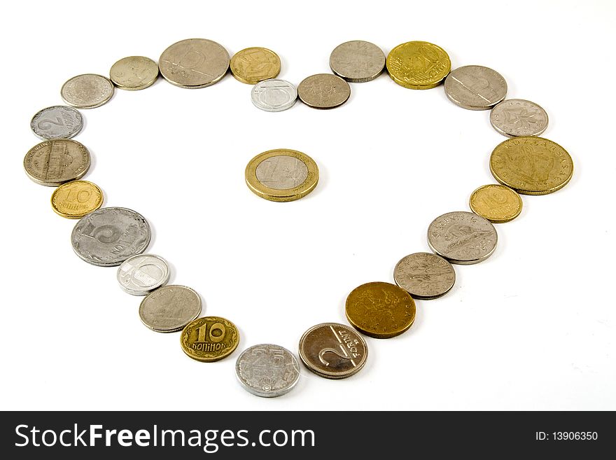 Different countries coins in a shape of a heart with a one euro coin in the middle