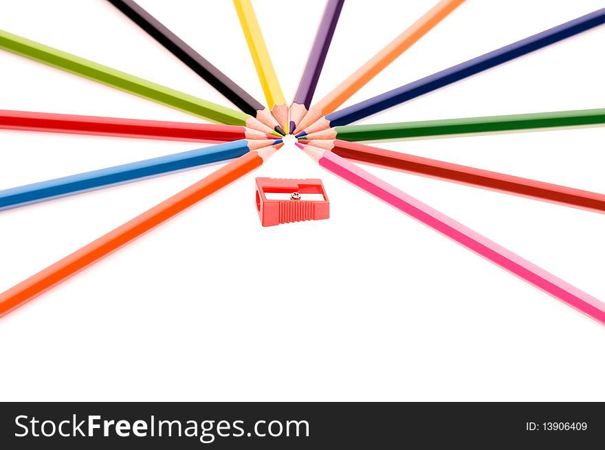 Close-up image of multicolor pencils and red sharpener isolated on white background